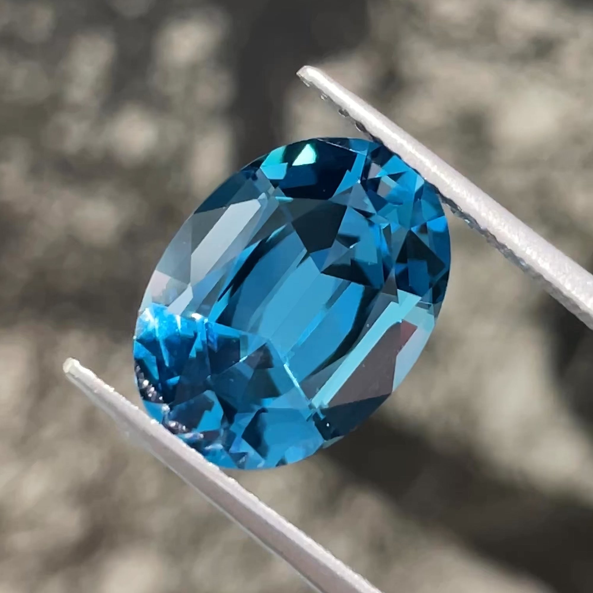 6.22 ct London Blue Topaz with Swiss Blue undertones, face-up view, neutral background