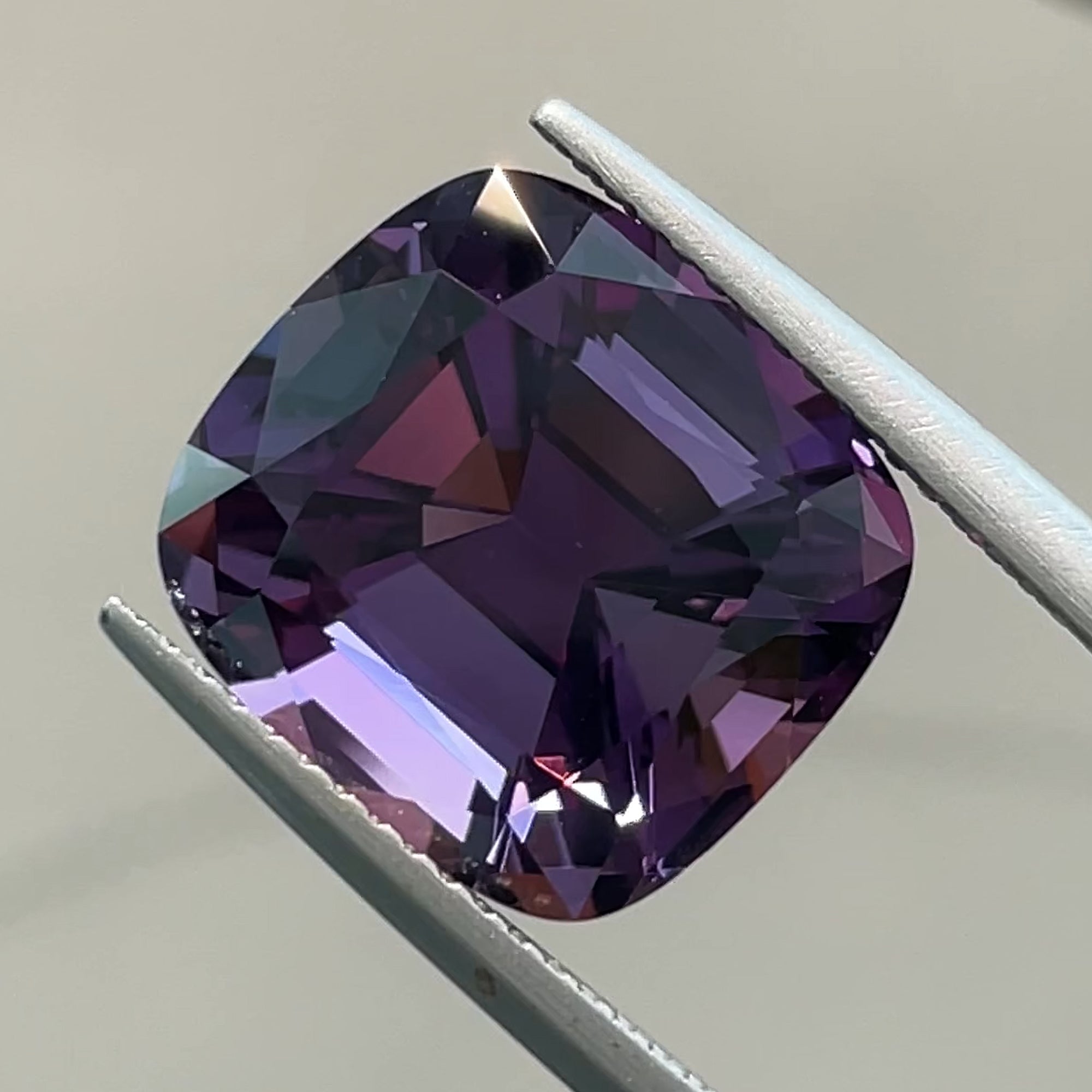 Precision cut 8.12 ct Rwandan Amethyst, tweezers view, white background