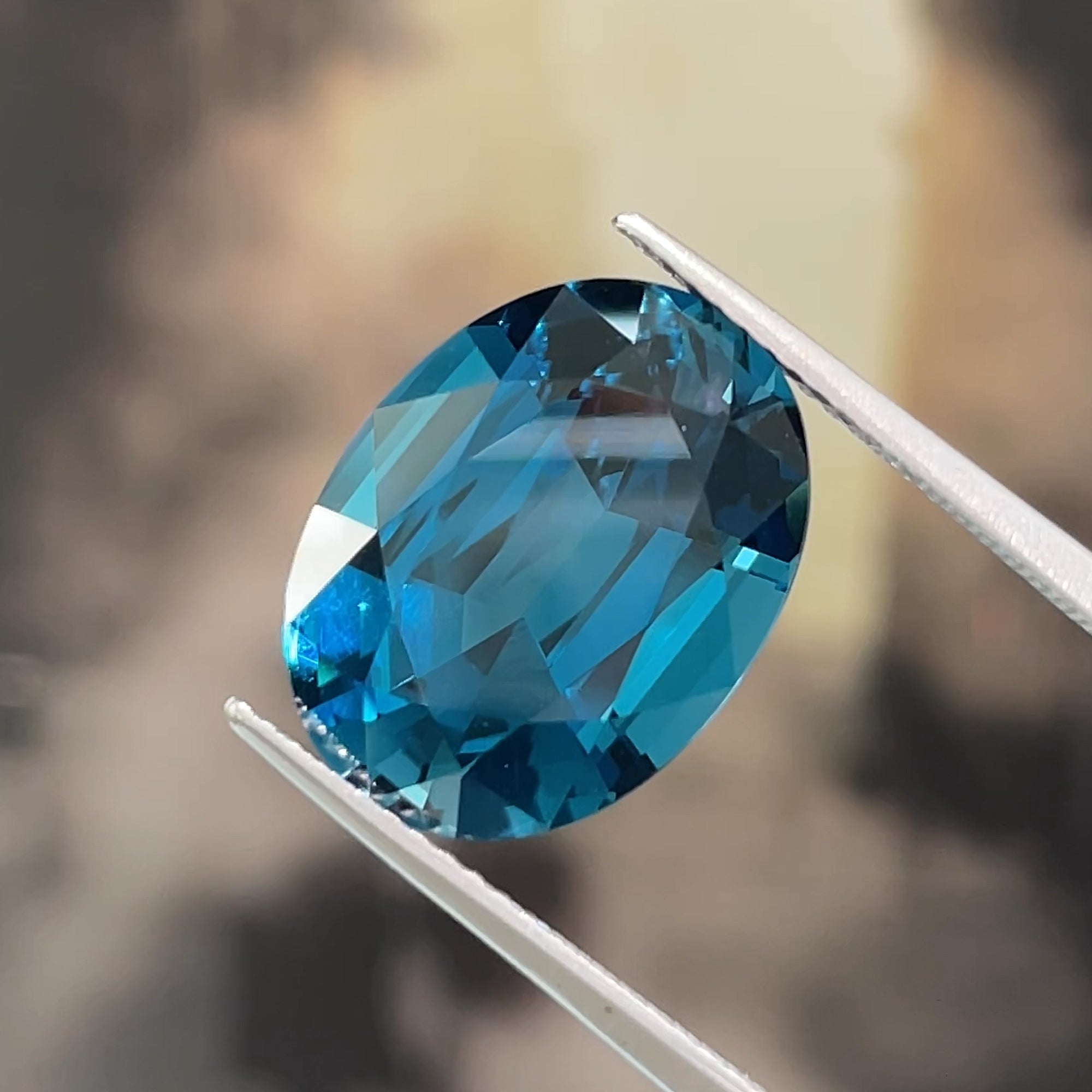 10.36 ct London Blue Topaz, face-up view, beige background