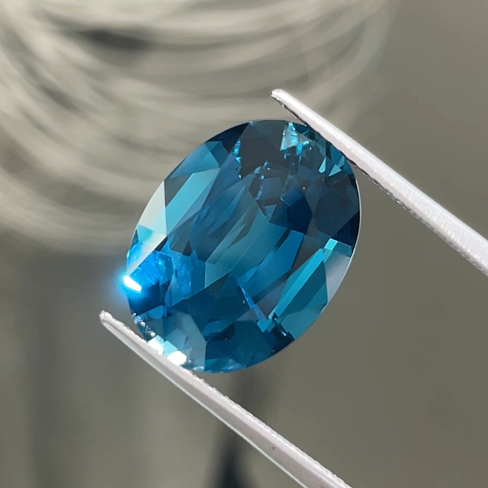 10.36 ct London Blue Topaz, face-up view, neutral grey background