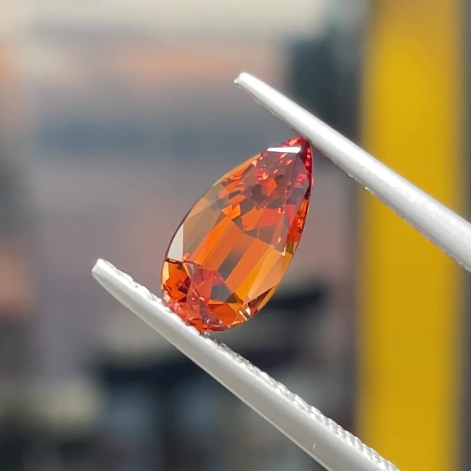 Precision Cut 1.16 carat Reddish Orange Malaya garnet from Tanzania, tweezers view