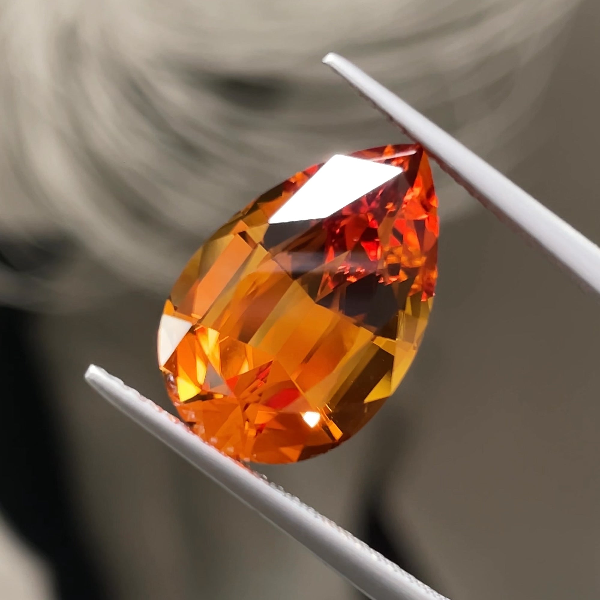 6.80 ct Santa Ana Madeira Citrine, precision cut, tweezers view, grey background
