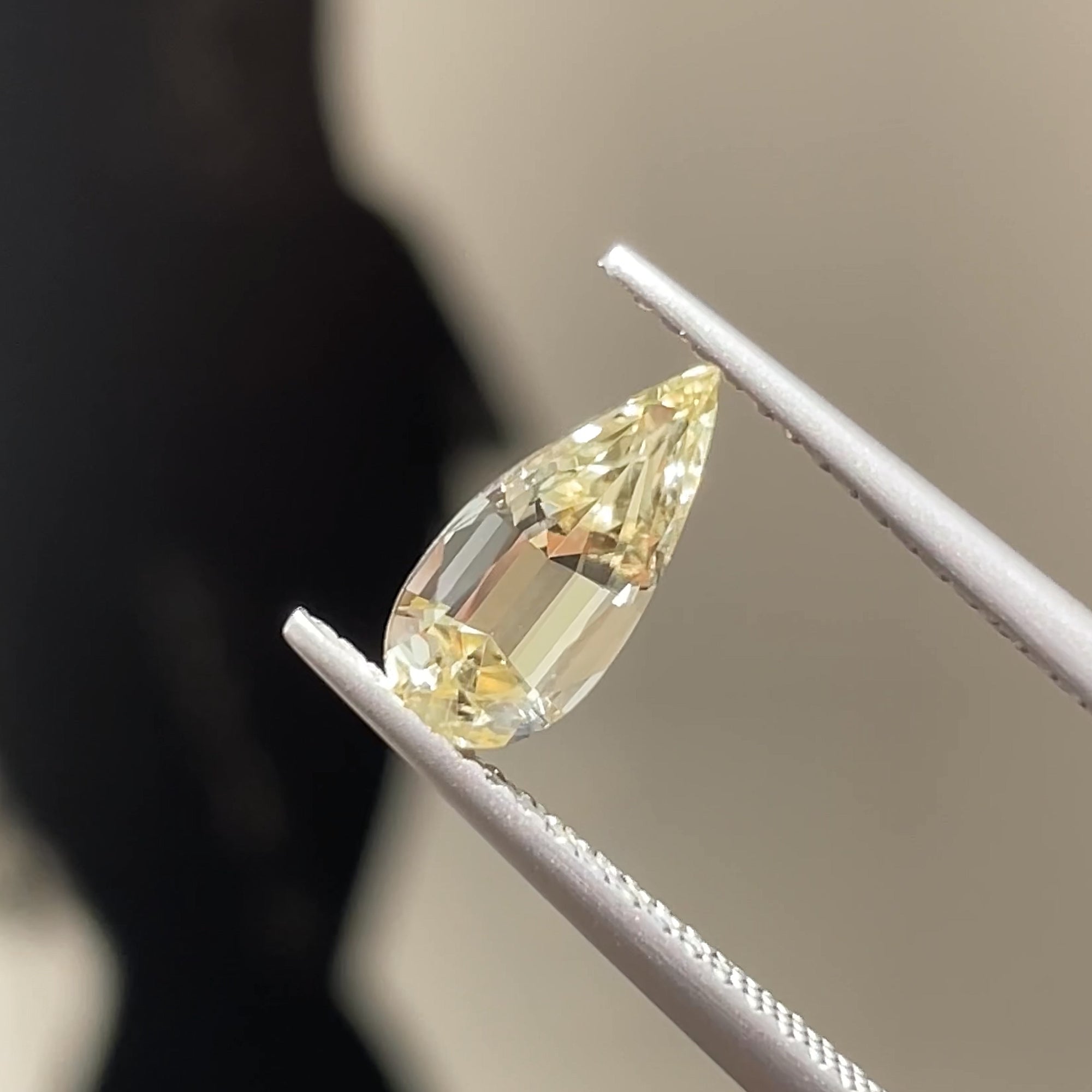 1.28 ct Precision Cut Yellow Chrysoberyl, Pear shape, tweezers view, neutral background