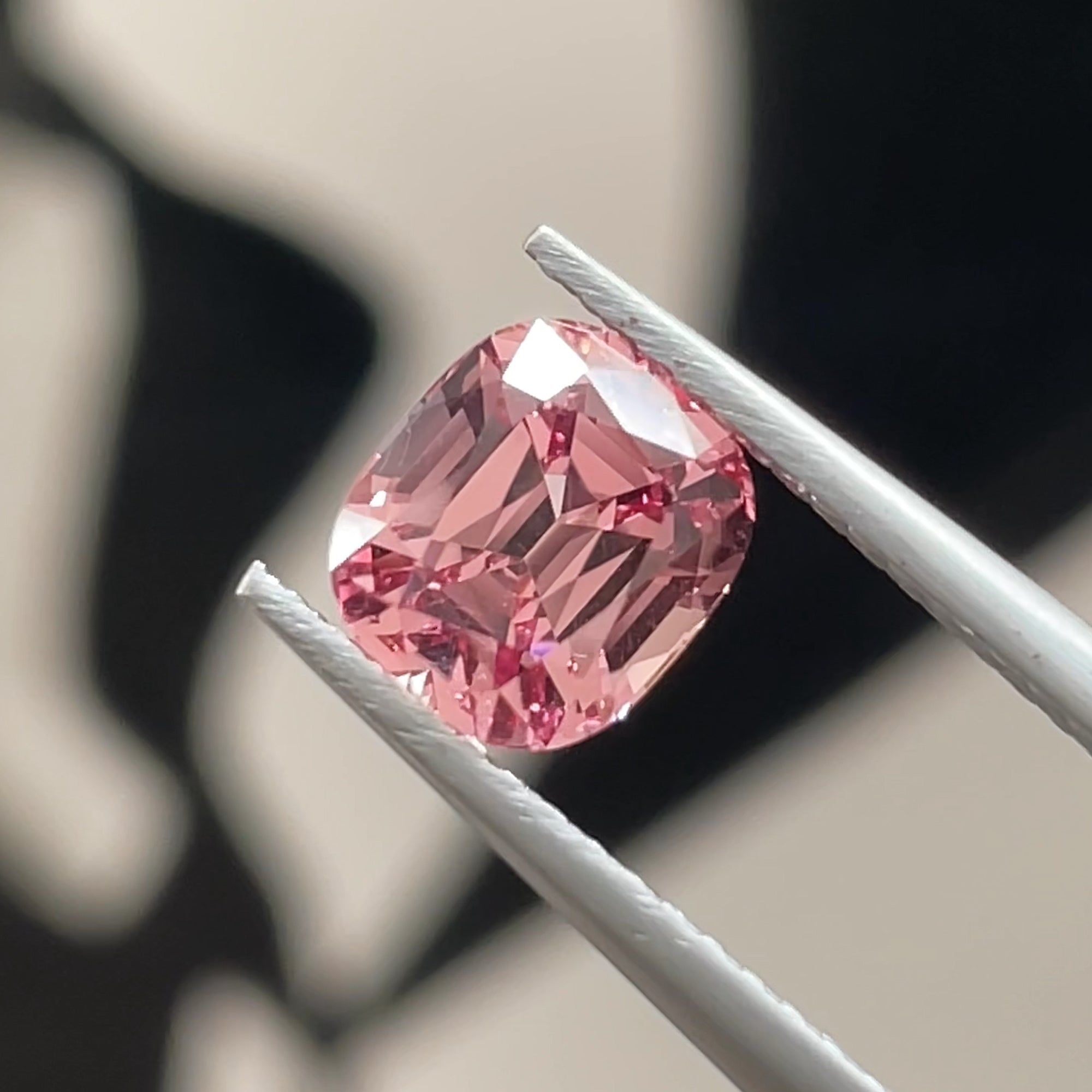 1.77 ct Malaya Mahenge Garnet, Precision Cut, Tweezers view, black and white background